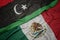 Waving colorful flag of mexico and national flag of libya.