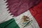 Waving colorful flag of mexico and national flag of qatar.