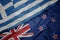 waving colorful flag of new zealand and national flag of greece