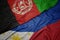 waving colorful flag of philippines and national flag of afghanistan