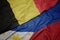 waving colorful flag of philippines and national flag of belgium