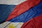 waving colorful flag of philippines and national flag of czech republic