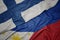 waving colorful flag of philippines and national flag of finland