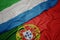 waving colorful flag of portugal and national flag of sierra leone