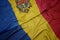 waving colorful flag of romania and national flag of moldova