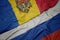 waving colorful flag of russia and national flag of moldova