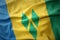 Waving colorful flag of saint vincent and the grenadines.