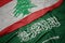 waving colorful flag of saudi arabia and national flag of lebanon