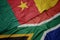 waving colorful flag of south africa and national flag of cameroon