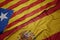 waving colorful flag of spain and national flag of catalonia