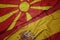 waving colorful flag of spain and national flag of macedonia