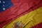 waving colorful flag of spain and national flag of Samoa