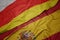 waving colorful flag of spain and national flag of south ossetia