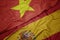 waving colorful flag of spain and national flag of vietnam