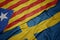 waving colorful flag of sweden and national flag of catalonia