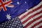 waving colorful flag of united states of america and national flag of australia