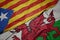 waving colorful flag of wales and national flag of catalonia