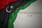 waving colorful national flag of libya on a gray background with text independence day