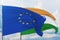 Waving European Union flag and flag of India. Closeup view, 3D illustration.