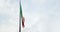 Waving fabric texture of the flag of italy on blue sky with clouds,