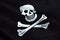 Waving fabric texture of the pirate flag waving in wind, calico jack pirate symbol, hacker and robber