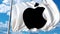 Waving flag with Apple logo against moving clouds. 4K editorial animation