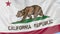 Waving flag of California state against blue sky. Seamless loop 4K clip