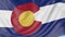 Waving flag of Colorado state against blue sky. Seamless loop 4K clip