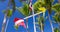 Waving flag of Dominican Republic, yellowand scuba diving banner on wind on blue sky with clouds and palm tree background