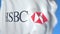 Waving flag with HSBC Holdings plc logo, close-up. Editorial 3D rendering