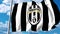 Waving flag with Juventus football team logo. 4K editorial clip