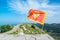 Waving flag of Montenegro against the background of mountains, near Njegos mausoleum in Lovcen National Park. Montenegro. Summer