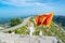 Waving flag of Montenegro against the background of mountains, near Njegos mausoleum in Lovcen National Park. Montenegro. Summer