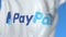 Waving flag with PayPal Holdings Inc. logo, close-up. Editorial 3D rendering