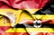 Waving flag of Uganda and Spain