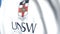 Waving flag with University of New South Wales emblem, close-up. Editorial loopable 3D animation