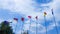 Waving flags of Australia, Armenia, China, Georgia, Iran, Romania and Sweden in the blue sky. Friendship of countries and peoples