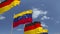 Waving flags of Venezuela and Germany on sky background, loopable 3D animation