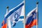 Waving Israeli flag close-up against flags of different countries in sunlight