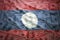 Waving laotian flag on a american dollar money background