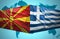 Waving Macedonian and Greek flags