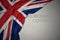 Waving national flag of great britain on a gray background with text coronavirus covid-19 . concept