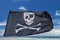 Waving pirate flag jolly roger on tropical island background