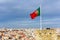 Waving portuguese flag on top of Saint Jorge Castle in Lisbon