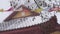 Waving Prayer Flags in Winter Weather, Buddhist Temple in Background, Close up