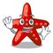 Waving red starfish animal on mascot sand