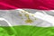 Waving Tajikistan flag for using as texture or background, the flag is fluttering on the wind