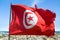 Waving tunisian flag on the background of the medieval medina in Sousse, Tunisia.