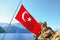 The waving Turkish flag and the gorgeous Mediterranean in Korsan Cove.