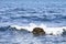 Waving water surface and stone of the Adriatic sea